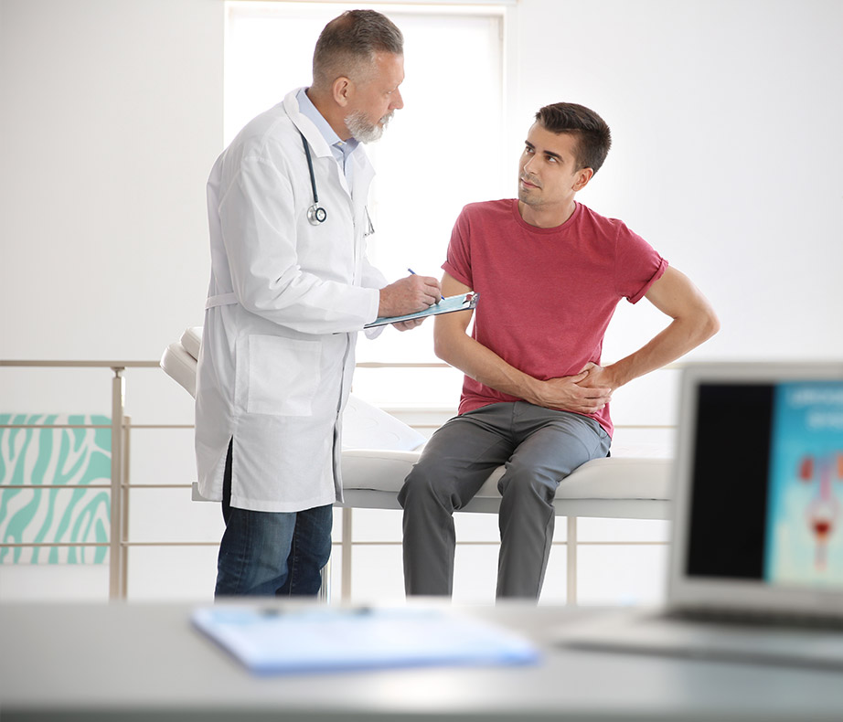 Male doctor helping adult male patient